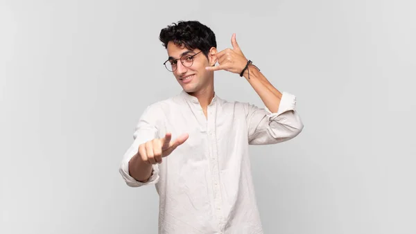 Young Handsome Man Smiling Cheerfully Pointing Camera While Making Call — Stock Photo, Image