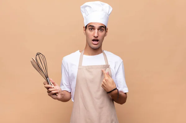 Young Baker Man Looking Shocked Surprised Mouth Wide Open Pointing — Stock Photo, Image