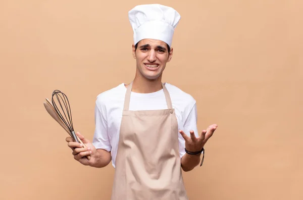Young Baker Man Looking Desperate Frustrated Stressed Unhappy Annoyed Shouting — Stock Photo, Image