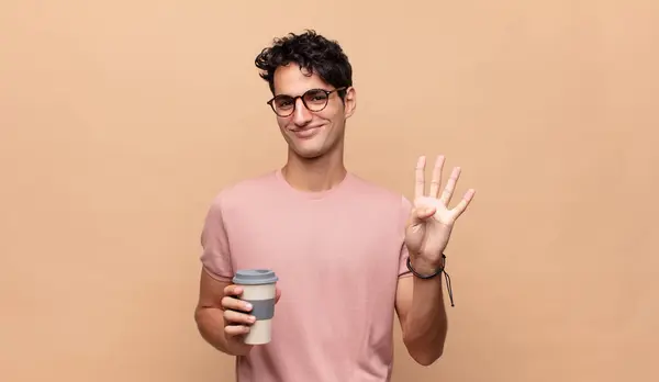 Joven Hombre Guapo Con Café Sonriendo Buscando Amigable Mostrando Número — Foto de Stock