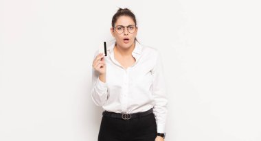 young blonde woman feeling puzzled and confused, with a dumb, stunned expression looking at something unexpected