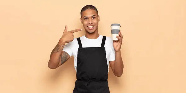 young black man smiling confidently pointing to own broad smile, positive, relaxed, satisfied attitude