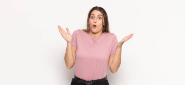 Genç sarışın kadın şok olmuş ve şaşkın görünüyor, inanılmaz bir şey fark ettiğinde çenesi şaşkın ve şaşkın