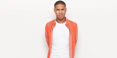 young black man feeling puzzled and confused, with a dumb, stunned expression looking at something unexpected
