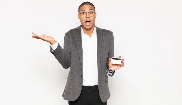 Young Black Man Looking Surprised Shocked Jaw Dropped Holding Object — Stock Photo, Image