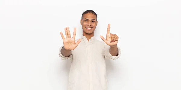 Young Black Man Smiling Looking Friendly Showing Number Seven Seventh — Stock Photo, Image