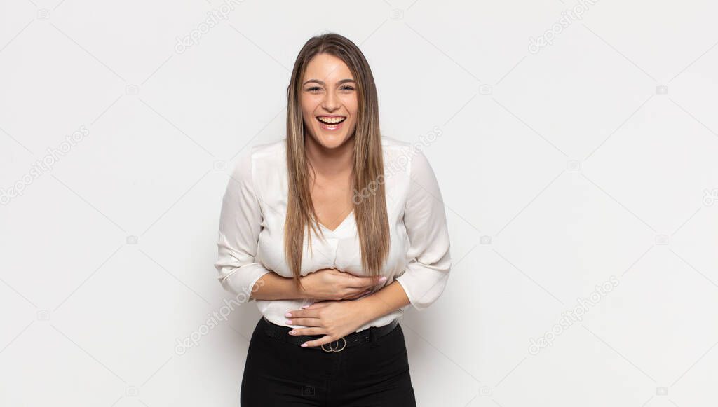 young blonde woman laughing out loud at some hilarious joke, feeling happy and cheerful, having fun