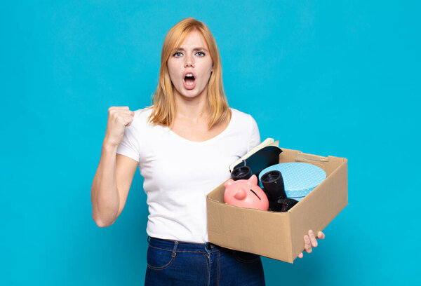 pretty woman  shouting aggressively with an angry expression or with fists clenched celebrating success