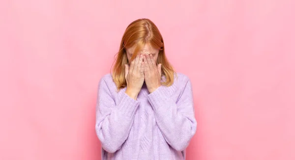 stock image red head pretty woman feeling sad, frustrated, nervous and depressed, covering face with both hands, crying