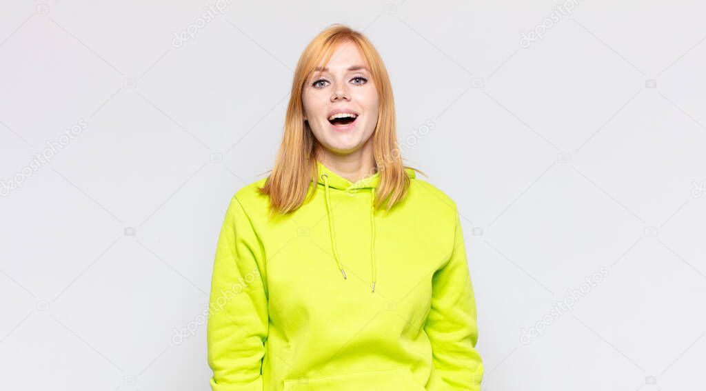 red head pretty woman with a big, friendly, carefree smile, looking positive, relaxed and happy, chilling