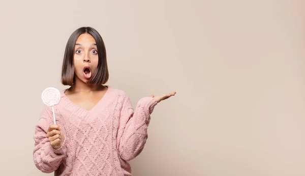 Giovane Donna Guardando Sorpreso Scioccato Con Mascella Caduto Tenendo Oggetto — Foto Stock