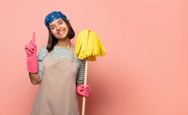 Young Woman Housekeeper Smiling Looking Friendly Showing Number One First — Stock Photo, Image