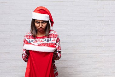 Genç kadın tuğla duvara karşı noel konsepti