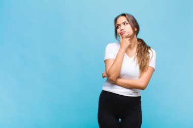 Genç İspanyol kadın düşünüyor, kuşkulu ve şaşkın hissediyor, farklı seçeneklerle, hangi kararı vereceğini merak ediyor.