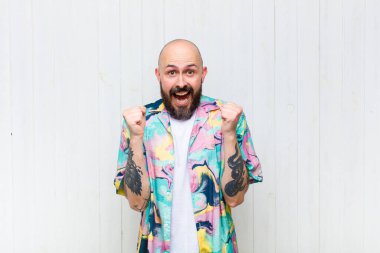 Kel adam şaşkın, heyecanlı ve mutlu hissediyor, gülüyor ve başarıyı kutluyor,!