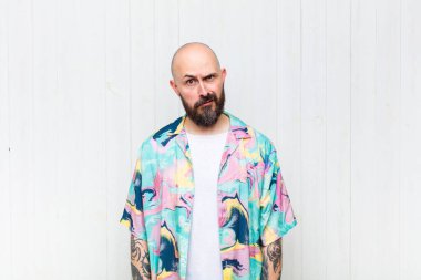 bald man feeling puzzled and confused, with a dumb, stunned expression looking at something unexpected