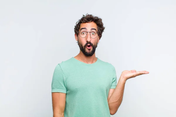 Young Bearded Man Looking Surprised Shocked Jaw Dropped Holding Object — Stock Photo, Image