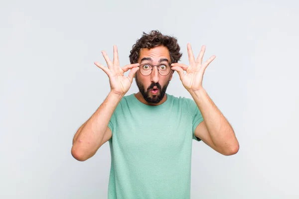 Young Bearded Man Feeling Shocked Amazed Surprised Holding Glasses Astonished — Stock Photo, Image