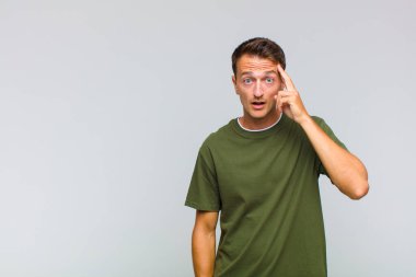 Genç yakışıklı adam şaşırmış, ağzı açık, şok olmuş, yeni bir düşünce, fikir ya da konsept keşfediyor.