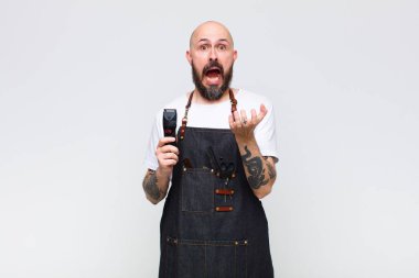 Kel adam umutsuz ve sinirli görünüyor, stresli, mutsuz ve sinirli, bağırıyor ve çığlık atıyor.