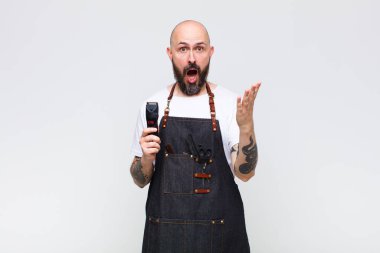 Kel adam son derece şok olmuş ve şaşırmış, endişeli ve panik içinde, stresli ve dehşete düşmüş bir bakışla