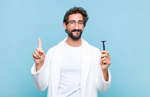 Young Bearded Man Smiling Looking Friendly Showing Number One First — Stock Photo, Image