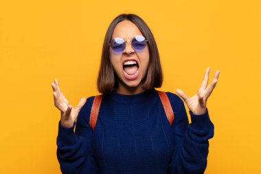 İspanyol kadın öfkeyle bağırıyor, stresli hissediyor ve ellerini havaya kaldırıp neden ben diye bağırıyor.