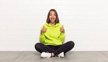 İspanyol kadın mutlu, pozitif, kendinden emin ve başarılı bir şekilde gülümsüyor.