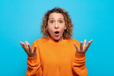 Orta yaşlı bir kadın inanılmaz bir sürprizle şaşkın ve şaşkın.