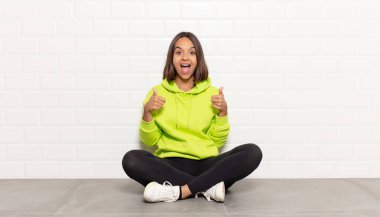 İspanyol kadın mutlu, pozitif, kendinden emin ve başarılı bir şekilde gülümsüyor.