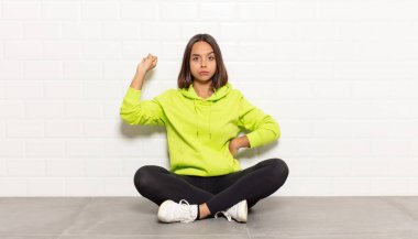 Hispanik kadın ciddi, güçlü ve asi hissediyor, yumruğunu kaldırıyor, protesto ediyor ya da devrim için savaşıyor.