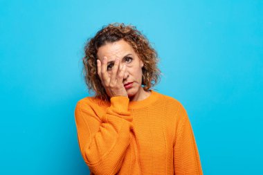 Orta yaşlı bir kadın yorgun, sıkıcı ve sıkıcı bir işten sonra sıkılmış, hayal kırıklığına uğramış ve uykulu hisseder.