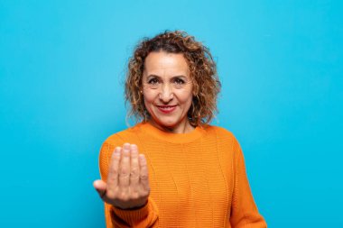 Orta yaşlı bir kadın mutlu, başarılı ve kendinden emin hissediyor, bir meydan okumayla karşı karşıya ve 