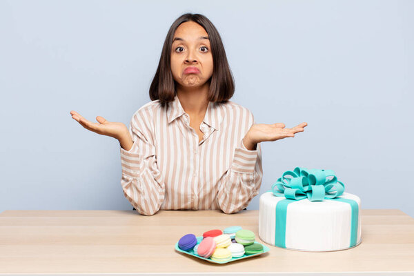 hispanic woman feeling puzzled and confused, doubting, weighting or choosing different options with funny expression