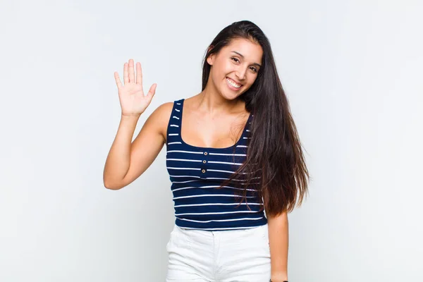 Young Woman Smiling Happily Cheerfully Waving Hand Welcoming Greeting You — Stock Photo, Image