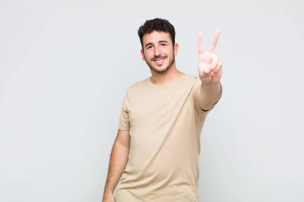 Young Man Smiling Looking Happy Carefree Positive Gesturing Victory Peace — Stock Photo, Image