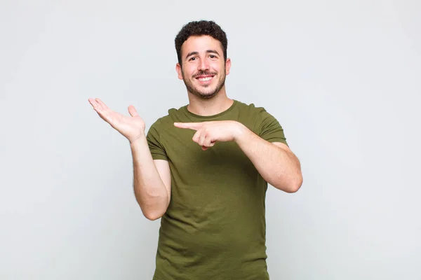 Young Man Smiling Cheerfully Pointing Copy Space Palm Side Showing — Stock Photo, Image