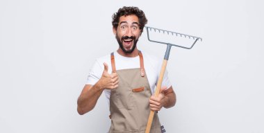 Genç adam gülümsüyor. Mutlu, pozitif, kendinden emin ve başarılı görünüyor.