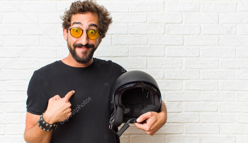 young man feeling happy, surprised and proud, pointing to self with an excited, amazed look