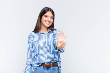 Güzel bir kadın gülümsüyor ve arkadaş canlısı görünüyor, dört ya da dört numarayı gösteriyor, eli önde, geriye doğru sayıyor.