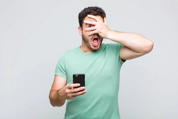 Young Man Looking Shocked Scared Terrified Covering Face Hand Peeking — Stock Photo, Image