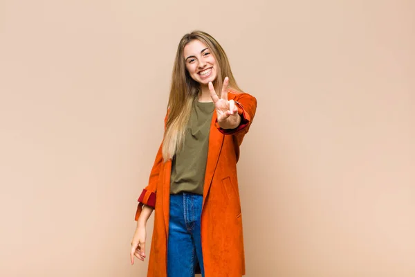 Blonde Woman Smiling Looking Happy Carefree Positive Gesturing Victory Peace — Stock Photo, Image