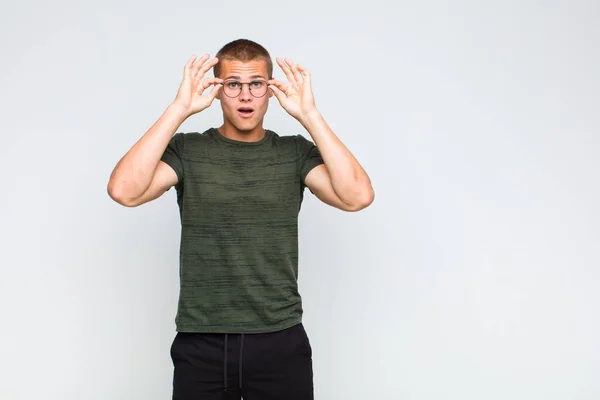 Blonde Man Feeling Shocked Amazed Surprised Holding Glasses Astonished Disbelieving — Stock Photo, Image