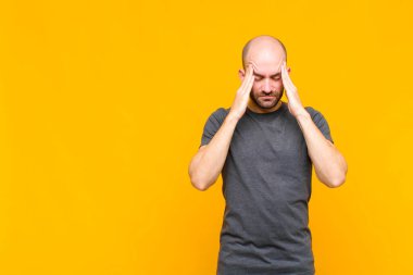 Kel adam konsantre olmuş, düşünceli ve ilham verici, beyin fırtınası yapıyor ve hayal kuruyor.