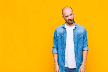 bald man feeling puzzled and confused, with a dumb, stunned expression looking at something unexpected