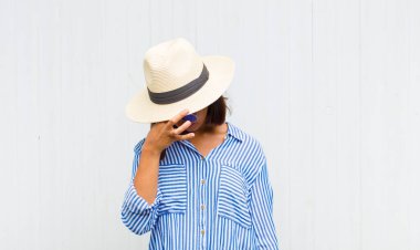 Latin kadın kendini stresli, mutsuz ve hayal kırıklığına uğramış hissediyor. Alnına dokunuyor ve şiddetli baş ağrısı çekiyor.