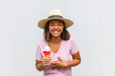 Genç İspanyol kadın komik bir şakaya yüksek sesle gülüyor, mutlu ve neşeli hissediyor, eğleniyor.