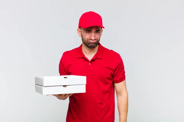 young bald man feeling sad and whiney with an unhappy look, crying with a negative and frustrated attitude