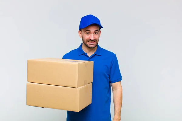 Stock image young bald man looking happy and pleasantly surprised, excited with a fascinated and shocked expression