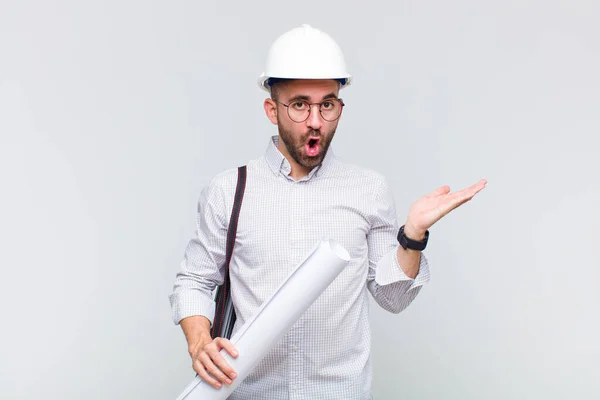 Young Bald Man Looking Surprised Shocked Jaw Dropped Holding Object — Stock Photo, Image